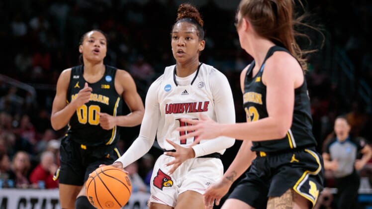Mar 28, 2022; Wichita, KS, USA; Louisville Cardinals guard Kianna Smith (14) drives to the basket against the Michigan Wolverines in the Wichita regional finals of the women's college basketball NCAA Tournament at INTRUST Bank Arena. Mandatory Credit: William Purnell-USA TODAY Sports