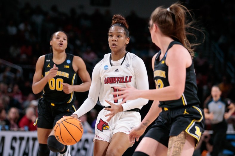 Mar 28, 2022; Wichita, KS, USA; Louisville Cardinals guard Kianna Smith (14) drives to the basket against the Michigan Wolverines in the Wichita regional finals of the women's college basketball NCAA Tournament at INTRUST Bank Arena. Mandatory Credit: William Purnell-USA TODAY Sports
