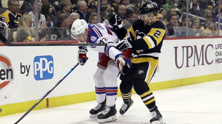 Mar 29, 2022; Pittsburgh, Pennsylvania, USA;  New York Rangers center Filip Chytil (72) is pressured by Pittsburgh Penguins defenseman Chad Ruhwedel (2) during the first period at PPG Paints Arena. Mandatory Credit: Charles LeClaire-USA TODAY Sports