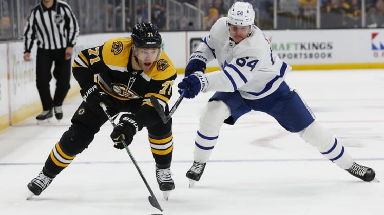 Mar 29, 2022; Boston, Massachusetts, USA; Boston Bruins left wing Taylor Hall (71) skates past Toronto Maple Leafs center David Kampf (64) during the first period at TD Garden. Mandatory Credit: Winslow Townson-USA TODAY Sports