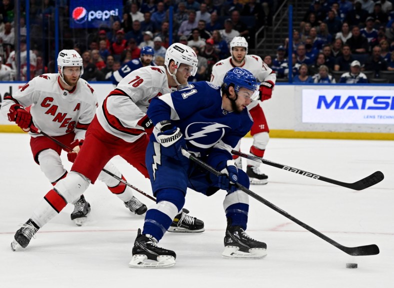 Mar 29, 2022; Tampa, Florida, USA; Tampa Bay Lightning center Anthony Cirelli (71) controls the puck as Carolina Hurricanes center Steven Lorentz (78) defends in the first period  at Amalie Arena. Mandatory Credit: Jonathan Dyer-USA TODAY Sports