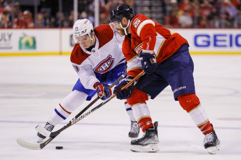 Mar 29, 2022; Sunrise, Florida, USA; Florida Panthers right wing Claude Giroux (28) battles for the puck against Montreal Canadiens center Jake Evans (71) during the first period at FLA Live Arena. Mandatory Credit: Sam Navarro-USA TODAY Sports