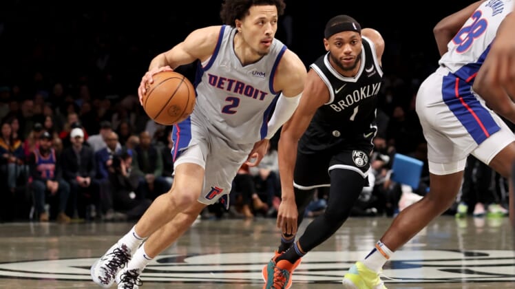 Mar 29, 2022; Brooklyn, New York, USA; Detroit Pistons guard Cade Cunningham (2) drives to the basket around Brooklyn Nets forward Bruce Brown (1) during the first quarter at Barclays Center. Mandatory Credit: Brad Penner-USA TODAY Sports