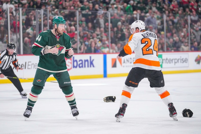 Mar 29, 2022; Saint Paul, Minnesota, USA;  Minnesota Wild left wing Nicolas Deslauriers (44) and Philadelphia Flyers defenseman Nick Seeler (24) square off to fight the first period at Xcel Energy Center. Mandatory Credit: Brad Rempel-USA TODAY Sports