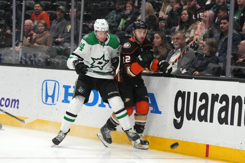 Mar 29, 2022; Anaheim, California, USA; Dallas Stars left wing Jamie Benn (14) and Anaheim Ducks defenseman Kevin Shattenkirk (22) battle for the puck in the first period at Honda Center. Mandatory Credit: Kirby Lee-USA TODAY Sports