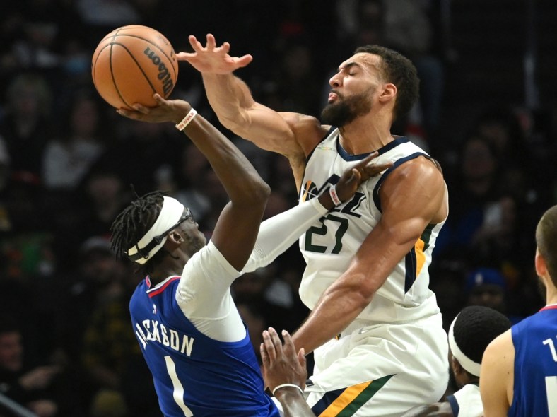 Mar 29, 2022; Los Angeles, California, USA;   Utah Jazz center Rudy Gobert (27) blocks a shot by Los Angeles Clippers guard Reggie Jackson (1) in the first half of the game at Crypto.com Arena. Mandatory Credit: Jayne Kamin-Oncea-USA TODAY Sports