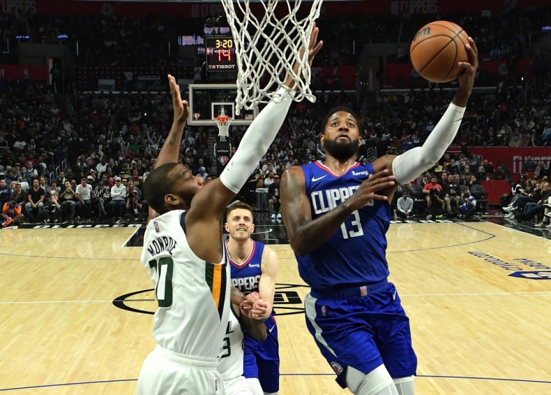 Mar 29, 2022; Los Angeles, California, USA; Los Angeles Clippers guard Paul George (13) drives for a basket past Utah Jazz Greg Monroe (10) in the second half of the game at Crypto.com Arena. Mandatory Credit: Jayne Kamin-Oncea-USA TODAY Sports