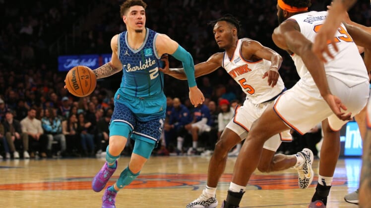 Mar 30, 2022; New York, New York, USA; Charlotte Hornets guard LaMelo Ball (2) controls the ball against New York Knicks guard Immanuel Quickley (5) and center Mitchell Robinson (23) during the second quarter at Madison Square Garden. Mandatory Credit: Brad Penner-USA TODAY Sports