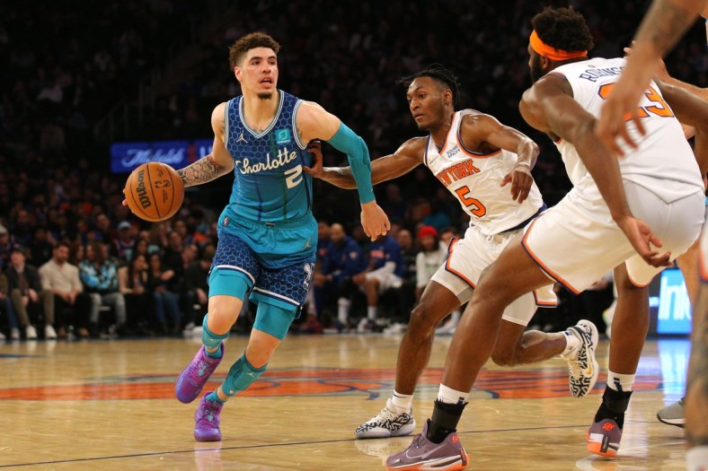 Mar 30, 2022; New York, New York, USA; Charlotte Hornets guard LaMelo Ball (2) controls the ball against New York Knicks guard Immanuel Quickley (5) and center Mitchell Robinson (23) during the second quarter at Madison Square Garden. Mandatory Credit: Brad Penner-USA TODAY Sports