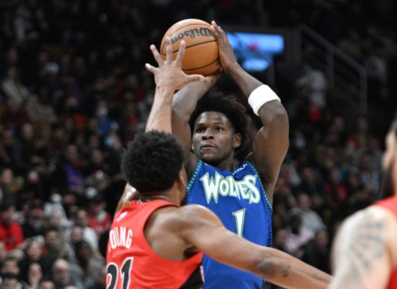 Mar 30, 2022; Toronto, Ontario, CAN; Minnesota Timberwolves guard Anthony Edwards (1) shoots the ball over Toronto Raptors forward Thaddeus Young (21) in the first half at Scotiabank Arena. Mandatory Credit: Dan Hamilton-USA TODAY Sports