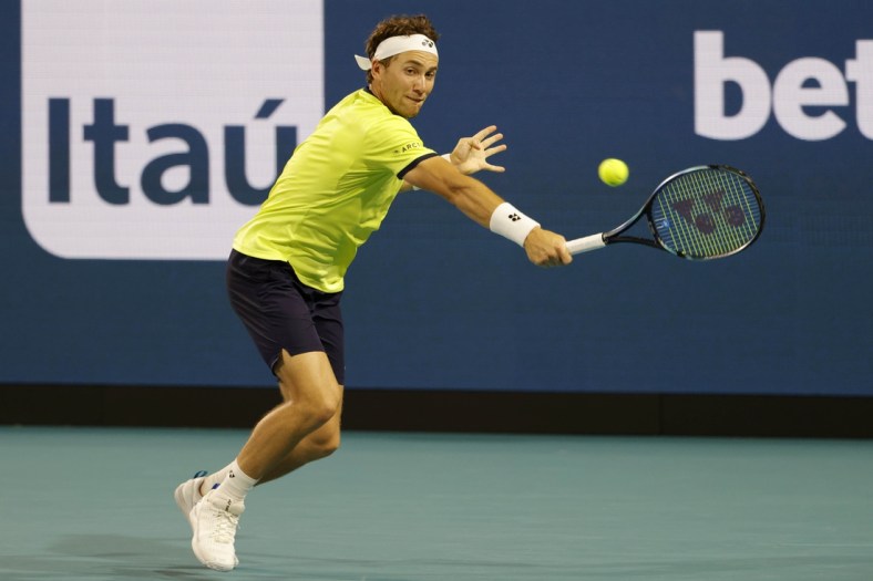 Mar 30, 2022; Miami Gardens, FL, USA; Casper Ruud (NOR) hits a backhand against Alexander Zverev (GER)(not pictured) in a men's singles quarterfinal match in the Miami Open at Hard Rock Stadium. Mandatory Credit: Geoff Burke-USA TODAY Sports