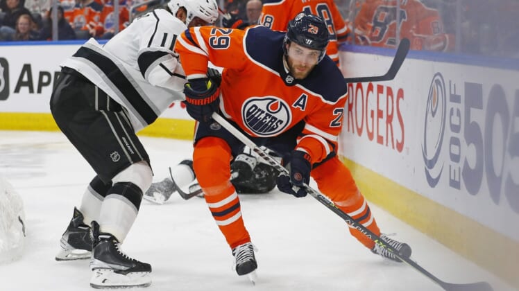 Mar 30, 2022; Edmonton, Alberta, CAN; Edmonton Oilers forward Leon Draisaitl (29) and Los Angeles Kings forward Anze Kopitar (11) battle along the boards for a loose puck during the third period at Rogers Place. Mandatory Credit: Perry Nelson-USA TODAY Sports
