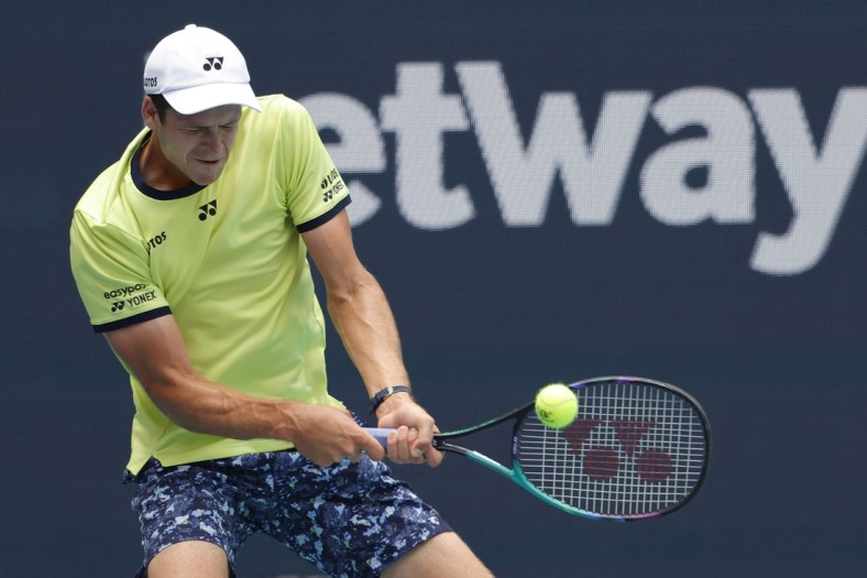 Mar 31, 2022; Miami Gardens, FL, USA; Hubert Hurkacz (POL) hits a backhand against Daniil Medvedev (not pictured) in a men's singles quarterfinal in the Miami Open at Hard Rock Stadium. Mandatory Credit: Geoff Burke-USA TODAY Sports