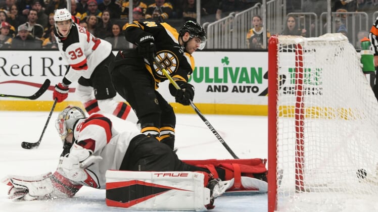 Mar 31, 2022; Boston, Massachusetts, USA; Boston Bruins left wing Jake DeBrusk (74) scores a goal past New Jersey Devils goaltender Nico Daws (50) during the first period at the TD Garden. Mandatory Credit: Brian Fluharty-USA TODAY Sports
