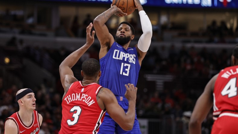 Mar 31, 2022; Chicago, Illinois, USA; LA Clippers guard Paul George (13) shoots against Chicago Bulls center Tristan Thompson (3) during the first half at United Center. Mandatory Credit: Kamil Krzaczynski-USA TODAY Sports