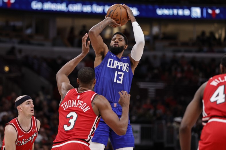 Mar 31, 2022; Chicago, Illinois, USA; LA Clippers guard Paul George (13) shoots against Chicago Bulls center Tristan Thompson (3) during the first half at United Center. Mandatory Credit: Kamil Krzaczynski-USA TODAY Sports