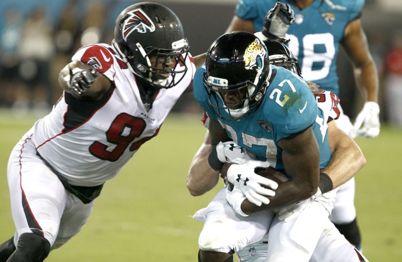 Aug 25, 2018; Jacksonville, FL, USA; Jacksonville Jaguars running back Leonard Fournette (27) is stopped as Atlanta Falcons defensive tackle Deadrin Senat (94) closes in during the second quarter at TIAA Bank Field. Mandatory Credit: Reinhold Matay-USA TODAY Sports