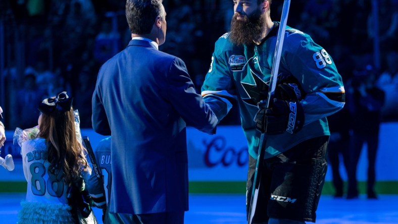 Jan 12, 2019; San Jose, CA, USA; San Jose Sharks general manager Doug Wilson congratulates San Jose Sharks defenseman Brent Burns (88) in a ceremony commemorating Burns playing 1000 games before the game against the Ottawa Senators  at SAP Center at San Jose. Mandatory Credit: John Hefti-USA TODAY Sports