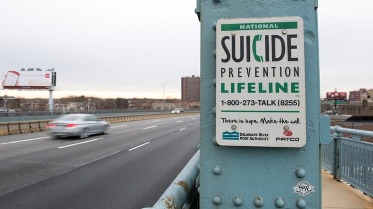 A sign for the National Suicide Prevention Hotline on the Camden side of the Benjamin Franklin Bridge.