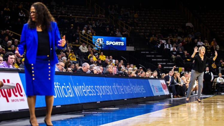 Iowa head coach Lisa Bluder, far right, calls out to players while Rutgers head coach C. Vivian Stringer, left, looks to her bench during a NCAA Big Ten Conference women's basketball game on Wednesday, Jan. 23, 2019, at Carver-Hawkeye Arena in Iowa City, Iowa.190123 Wbb Rutgers 018 Jpg