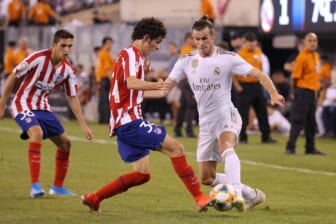 Jul 26, 2019; East Rutherford, NJ, USA; Real Madrid forward Gareth Bale (11) dribbles the ball as Atletico de Madrid forward Sergio Camello (34) defends during the second half of an International Champions Cup soccer series match at MetLife Stadium. Mandatory Credit: Brad Penner-USA TODAY Sports