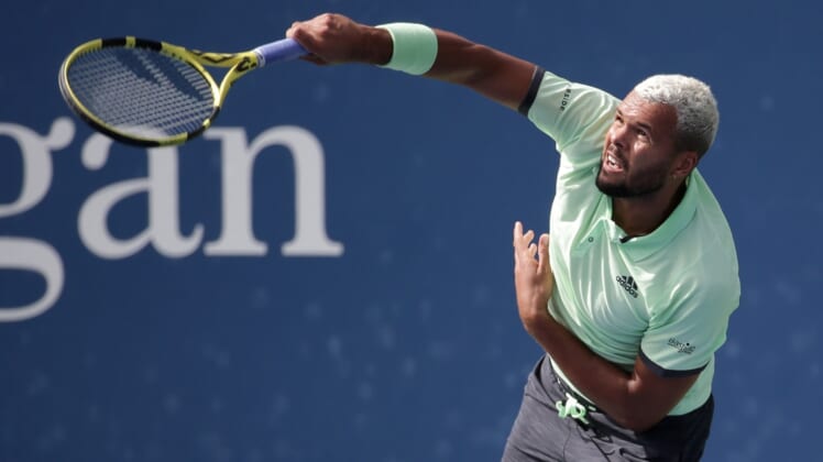 Aug 27, 2019; Flushing, NY, USA; Jo-Wilfried Tsonga of France hits to Tennys Sandgren of the United States in a first round match on day two of the 2019 U.S. Open tennis tournament at USTA Billie Jean King National Tennis Center. Mandatory Credit: Jerry Lai-USA TODAY Sports