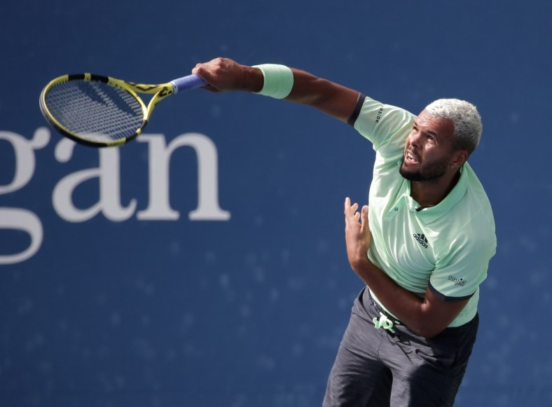 Aug 27, 2019; Flushing, NY, USA; Jo-Wilfried Tsonga of France hits to Tennys Sandgren of the United States in a first round match on day two of the 2019 U.S. Open tennis tournament at USTA Billie Jean King National Tennis Center. Mandatory Credit: Jerry Lai-USA TODAY Sports