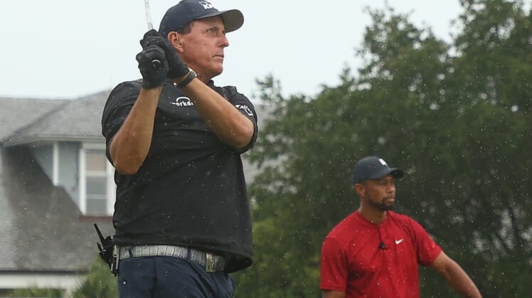 May 24, 2020; Hobe Sound, FL, USA; Phil Mickelson plays his shot from the first tee as Tiger Woods looks on during The Match: Champions for Charity golf round at the Medalist Golf Club.  Mandatory Credit: Handout Photo by Getty Images for The Match via USA TODAY Sports
