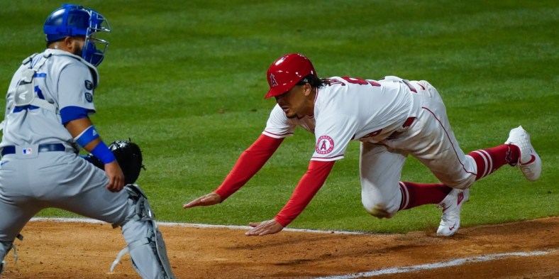 May 8, 2021; Anaheim, California, USA; Los Angeles Angels right fielder Jon Jay (9) slides head first into home plate to score on a double by Juan Lagares in the seventh inning at Angel Stadium. Los Angeles Dodgers catcher Austin Barnes waits for the throw. Mandatory Credit: Robert Hanashiro-USA TODAY Sports