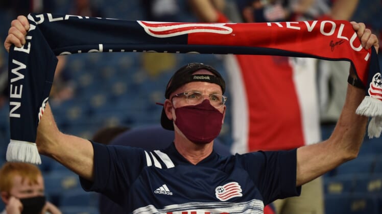 May 22, 2021; Foxborough, Massachusetts, USA;  A New England Revolution fan holds a banner as the New England Revolution and New York Red Bulls enter the field at Gillette Stadium. Mandatory Credit: Bob DeChiara-USA TODAY Sports