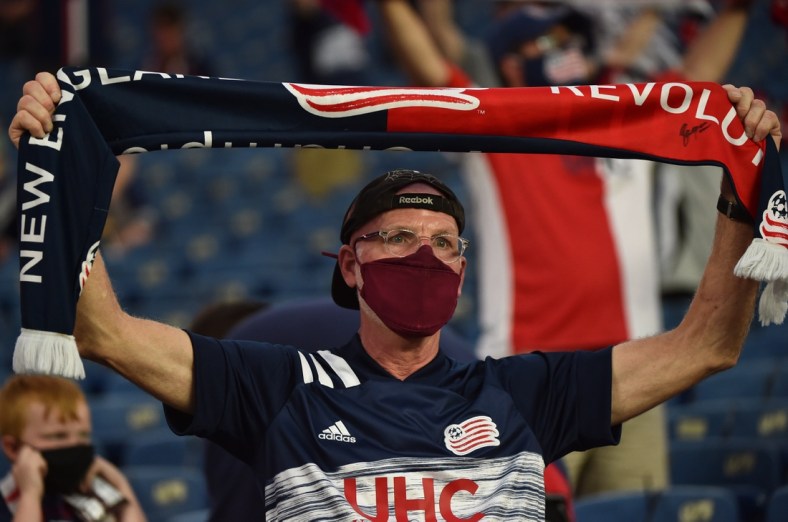 May 22, 2021; Foxborough, Massachusetts, USA;  A New England Revolution fan holds a banner as the New England Revolution and New York Red Bulls enter the field at Gillette Stadium. Mandatory Credit: Bob DeChiara-USA TODAY Sports