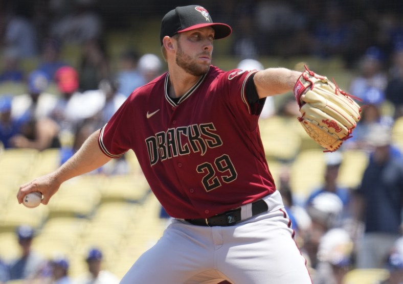 Jul 11, 2021; Los Angeles, California, USA; Arizona Diamondbacks starting pitcher Merrill Kelly (29) delivers a pitch during the first inning against the Los Angeles Dodgers at Dodger Stadium. Mandatory Credit: Robert Hanashiro-USA TODAY Sports
