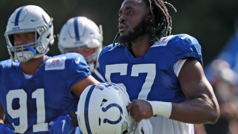 Colts' #57 Kemoko Turay gets his helmet ready to work out during Colts training camp practice Tuesday, Aug. 3, 2021 at Grand Park in Westfield.

Colts Training Camp