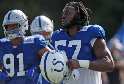 Colts' #57 Kemoko Turay gets his helmet ready to work out during Colts training camp practice Tuesday, Aug. 3, 2021 at Grand Park in Westfield.

Colts Training Camp