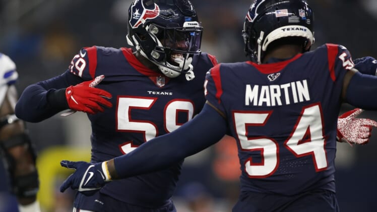 Aug 21, 2021; Arlington, Texas, USA; Houston Texans outside linebacker Whitney Mercilus (59) and linebacker Jake Martin (54) celebrate a turnover in the first quarter against the Dallas Cowboys at AT&T Stadium. Mandatory Credit: Tim Heitman-USA TODAY Sports