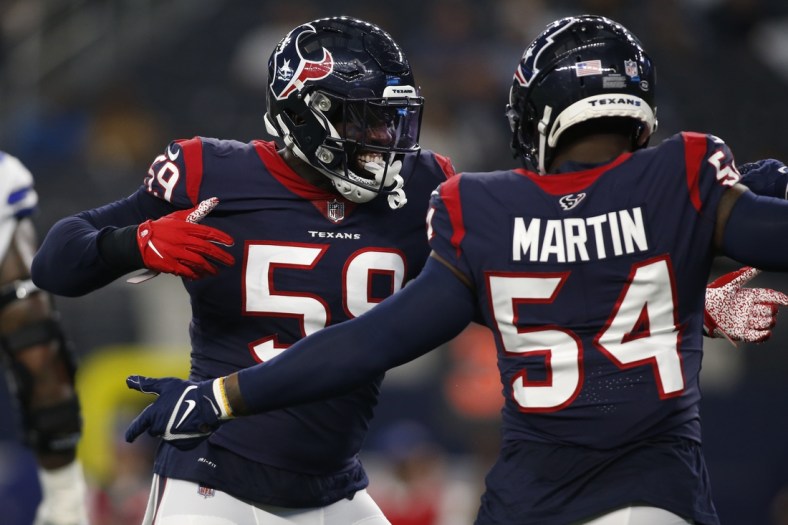 Aug 21, 2021; Arlington, Texas, USA; Houston Texans outside linebacker Whitney Mercilus (59) and linebacker Jake Martin (54) celebrate a turnover in the first quarter against the Dallas Cowboys at AT&T Stadium. Mandatory Credit: Tim Heitman-USA TODAY Sports