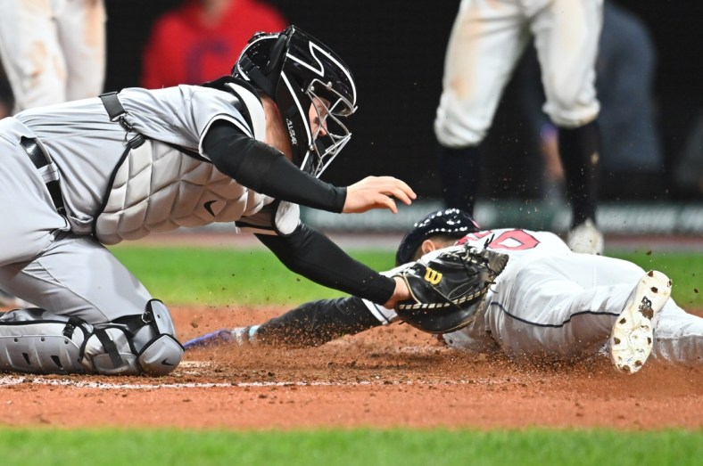 iSep 23, 2021; Cleveland, Ohio, USA; Cleveland Indians pinch runner Andres Gimenez (0) scores under the tag of Chicago White Sox catcher Zack Collins (21) during the sixth inning at Progressive Field. Mandatory Credit: Ken Blaze-USA TODAY Sports
