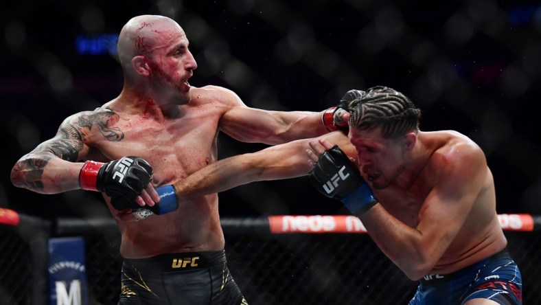 Sep 25, 2021; Las Vegas, Nevada, USA; Brian Ortega lands a hit against Alexander Volkanovski during UFC 266 at T-Mobile Arena. Mandatory Credit: Gary A. Vasquez-USA TODAY Sports