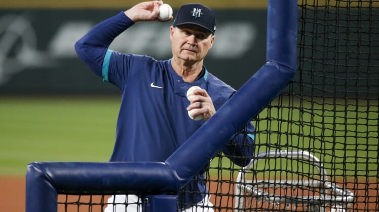 Sep 29, 2021; Seattle, Washington, USA; Seattle Mariners manager Scott Servais (9) throws batting practice to his players before a game against the Oakland Athletics at T-Mobile Park. Mandatory Credit: Joe Nicholson-USA TODAY Sports