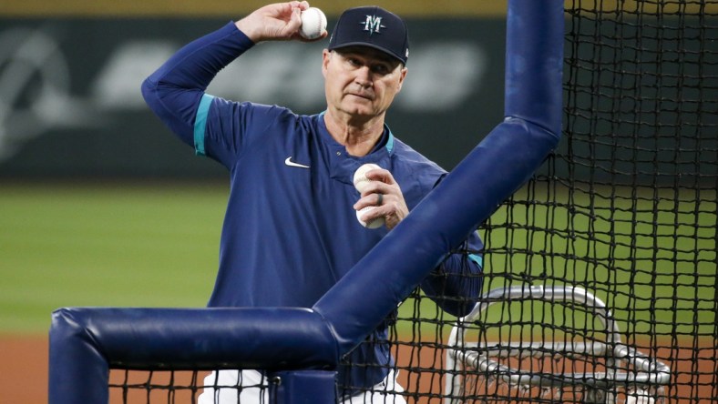 Sep 29, 2021; Seattle, Washington, USA; Seattle Mariners manager Scott Servais (9) throws batting practice to his players before a game against the Oakland Athletics at T-Mobile Park. Mandatory Credit: Joe Nicholson-USA TODAY Sports