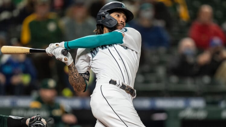Sep 27, 2021; Seattle, Washington, USA;  Seattle Mariners rightfielder Mitch Haniger (17) takes a swing during an at-bat in a game against the Oakland Athletics at T-Mobile Park. The Mariners won 13-4. Mandatory Credit: Stephen Brashear-USA TODAY Sports
