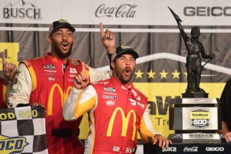Oct 4, 2021; Talladega, Alabama, USA; NASCAR Cup Series driver Bubba Wallace (23) celebrates with the trophy after winning the YellaWood 500 at Talladega Superspeedway. Mandatory Credit: Adam Hagy-USA TODAY Sports