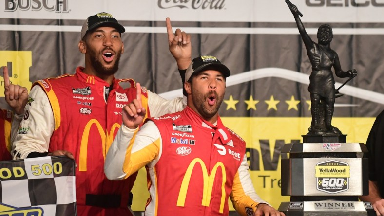 Oct 4, 2021; Talladega, Alabama, USA; NASCAR Cup Series driver Bubba Wallace (23) celebrates with the trophy after winning the YellaWood 500 at Talladega Superspeedway. Mandatory Credit: Adam Hagy-USA TODAY Sports