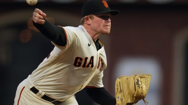 Oct 14, 2021; San Francisco, California, USA; San Francisco Giants starting pitcher Logan Webb (62) throws against the Los Angeles Dodgers during the second inning in game five of the 2021 NLDS at Oracle Park. Mandatory Credit: Neville E. Guard-USA TODAY Sports