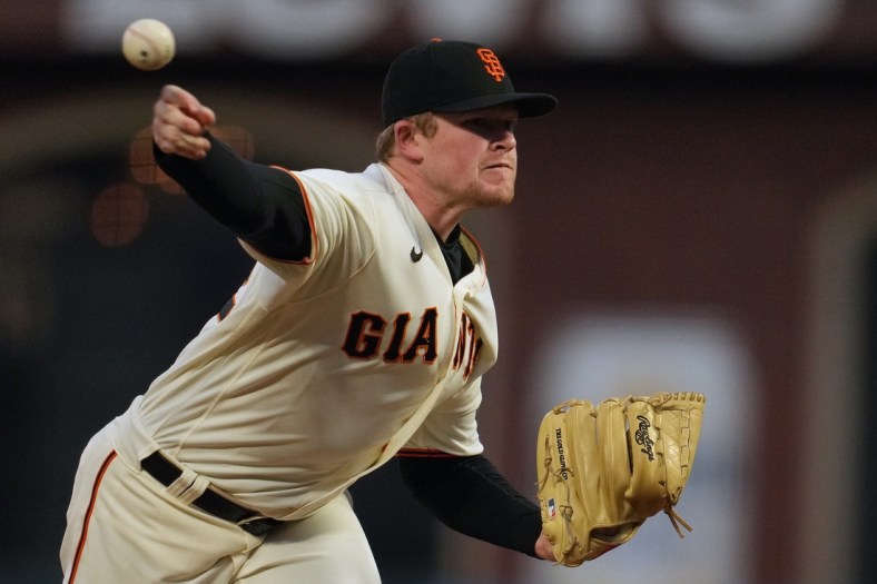 Oct 14, 2021; San Francisco, California, USA; San Francisco Giants starting pitcher Logan Webb (62) throws against the Los Angeles Dodgers during the second inning in game five of the 2021 NLDS at Oracle Park. Mandatory Credit: Neville E. Guard-USA TODAY Sports