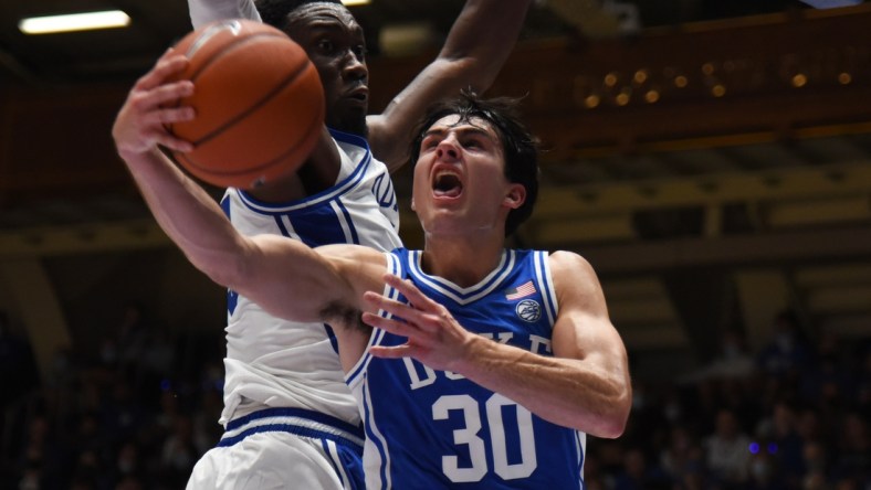 Oct 15, 2021; Durham, NC, USA;  Duke Blue Devils guard Michael Savarino (30) lays the ball up as center Mark Williams(15) defends during Duke Countdown to Craziness at Cameron Indoor Stadium. Mandatory Credit: Rob Kinnan-USA TODAY Sports