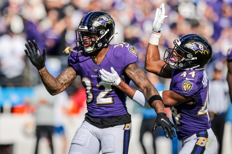 Oct 17, 2021; Baltimore, Maryland, USA; Baltimore Ravens free safety DeShon Elliott (32) celebrates a defensive stop with cornerback Marlon Humphrey (44) against the Los Angeles Chargers during the second half at M&T Bank Stadium. Mandatory Credit: Vincent Carchietta-USA TODAY Sports