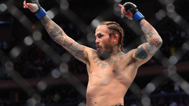 Nov 6, 2021; New York, NY, USA; Marlon Vera (blue gloves) celebrates after defeating Frankie Edgar (red gloves) during UFC 268 at Madison Square Garden. Mandatory Credit: Ed Mulholland-USA TODAY Sports