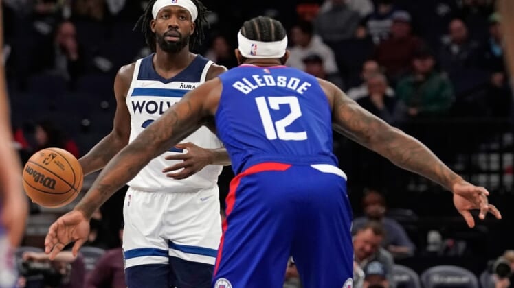 Nov 3, 2021; Minneapolis, Minnesota, USA;  Minnesota Timberwolves guard Patrick Beverly (22) controls the ball as Los Angeles Clippers guard Eric Bledsoe (12) defends at Target Center. Mandatory Credit: Nick Wosika-USA TODAY Sports