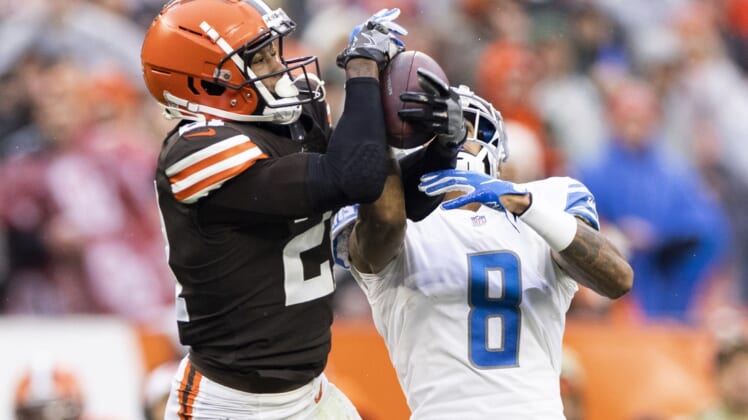 Nov 21, 2021; Cleveland, Ohio, USA; Cleveland Browns cornerback Denzel Ward (21) intercepts the ball from Detroit Lions wide receiver Josh Reynolds (8) during the third quarter at FirstEnergy Stadium. Mandatory Credit: Scott Galvin-USA TODAY Sports